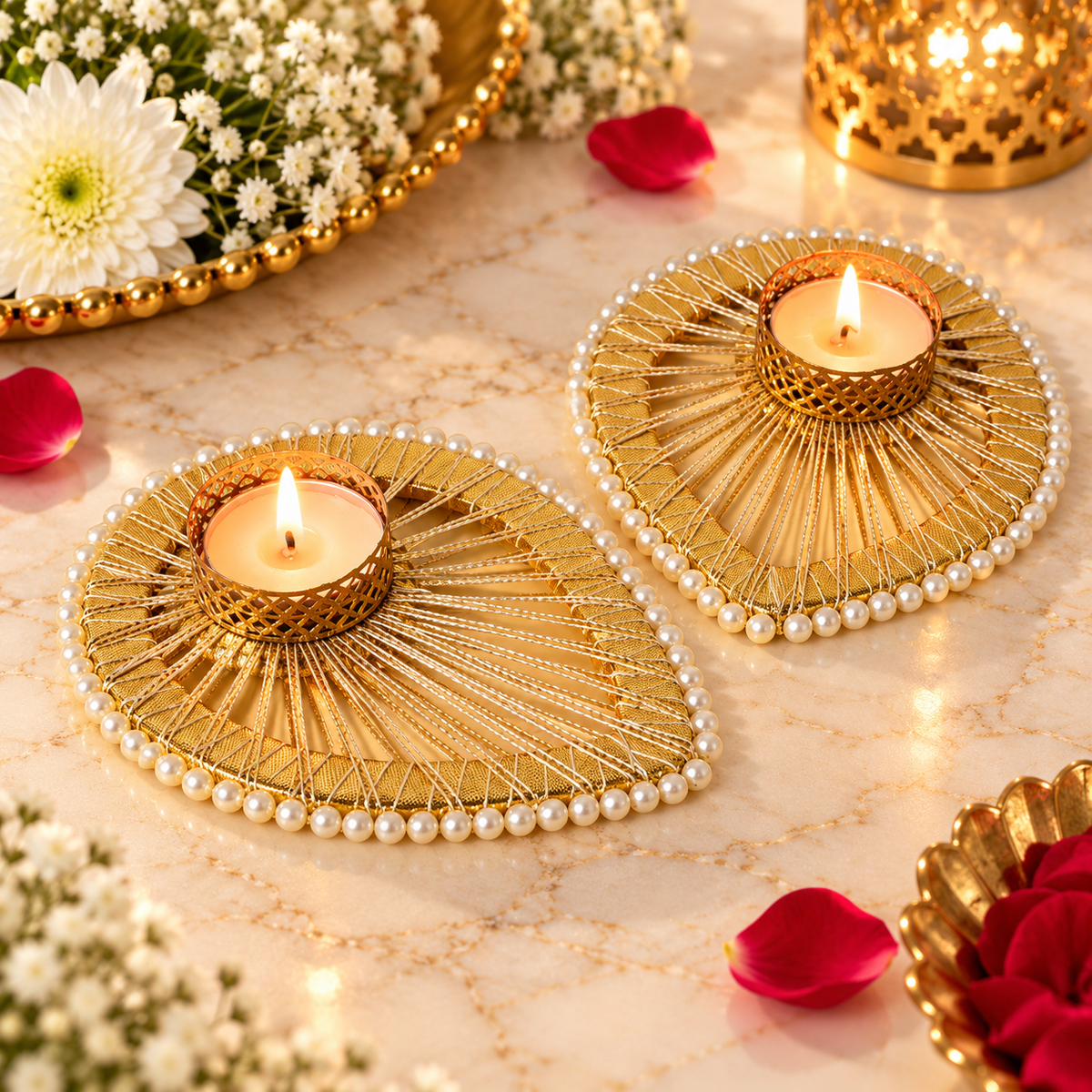 Two golden decorative T-light candle holders with intricate radial detailing and pearl borders, styled for Diwali and pooja decor.