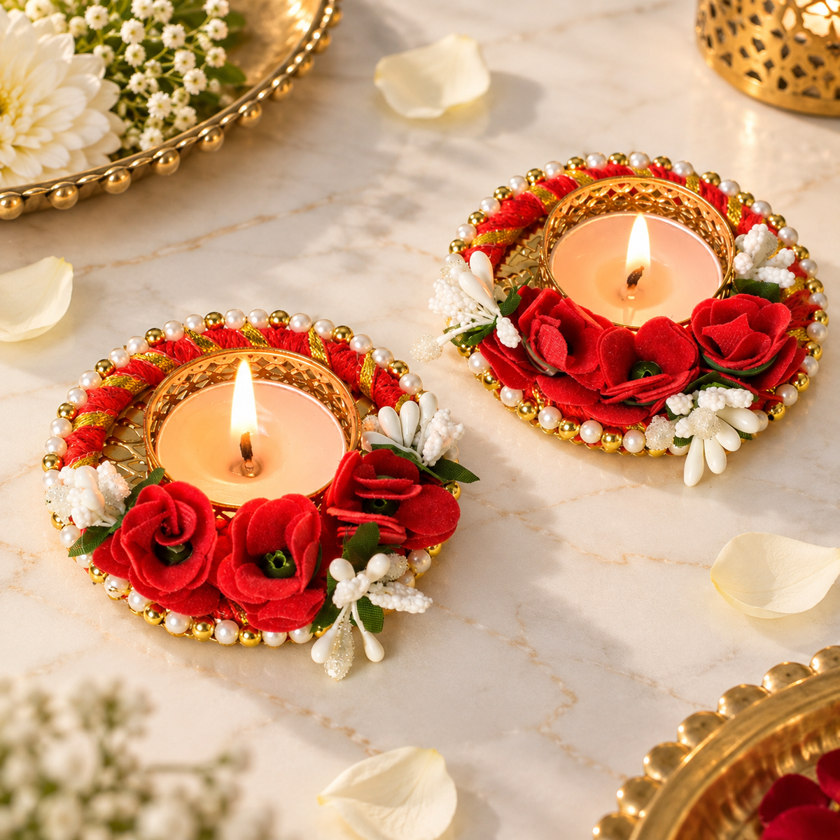 Set of two red rose decorative T-light candle holders with white floral accents, golden detailing, and pearl borders for festive decor.